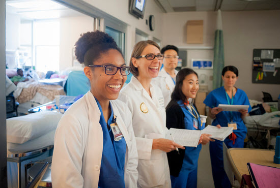 a group of resident physicians gathered around a patient